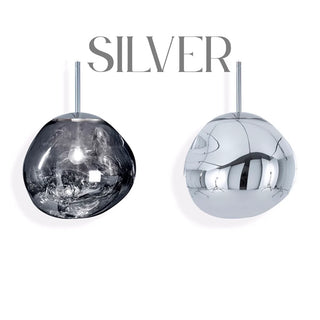 Elegant silver glass chandelier installed above a staircase, creating a floating bubble lighting effect.