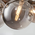 Close-up detail of smoked glass globe chandelier with visible LED bulb