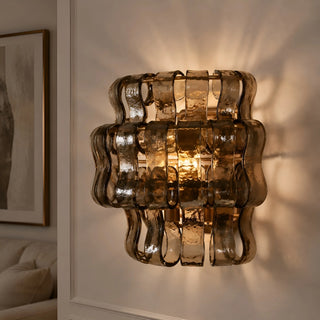 Smoked Murano glass wall sconce mounted in a modern living room interior creating warm decorative light patterns