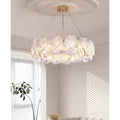 Modern moonlight white glass chandelier installed above sofa in bright contemporary living room