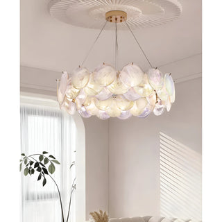 Modern moonlight white glass chandelier installed above sofa in bright contemporary living room