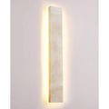 Full frontal view of Solea wall sconce with integrated LED softly highlighting natural stone