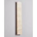 Unlit Solea sconce in full view showcasing pure travertine craftsmanship and geometric form