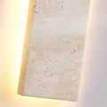 Detailed close-up of natural travertine texture with warm backlit illumination