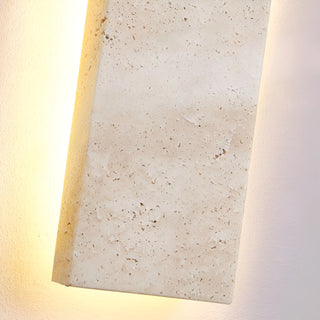 Detailed close-up of natural travertine texture with warm backlit illumination
