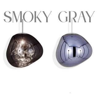 Multi pendant staircase chandelier with smoky gray glass globes suspended along curved stairs in a modern luxury home