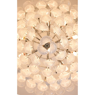 Close-up detail of textured glass chandelier with layered illuminated glass elements
