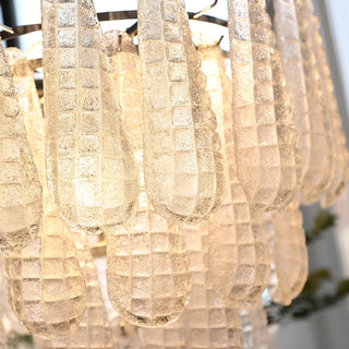 Close-up of textured Murano-style glass chandelier with illuminated handcrafted glass details