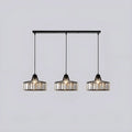 Triple black K9 crystal pendant lights in a linear ceiling bar arrangement for dining space