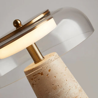 Detailed close-up of travertine lamp showing brass stem and clear glass dome reflecting warm LED light – MIRODEMI Italian lighting collection