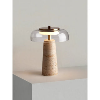 Minimalist table lamp with travertine base and clear glass dome, brass details and warm LED lighting, Italian modern design by MIRODEMI