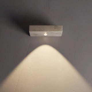 elegant stone wall sconce with upward beam and soft 4000K glow on grey surface