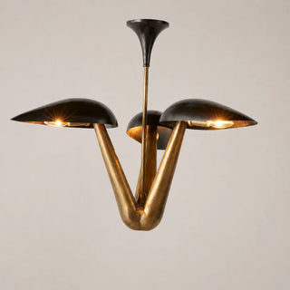 Trombara brass three-light mid-century chandelier with black dome shades, lit, front view on a white background
