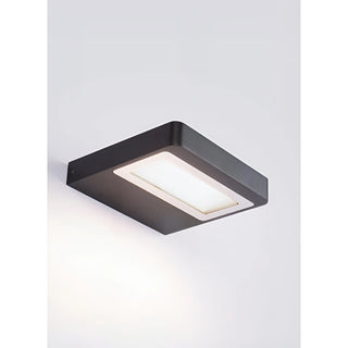Modern wall-mounted LED fixture casting soft white light on a light gray surface