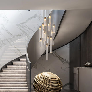 Glass tube pendant chandelier in the center of a marble spiral staircase