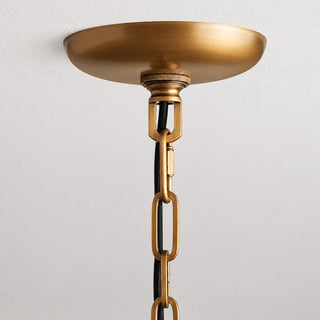 Gold ceiling canopy and chain attachment detail on the Vellori pendant light