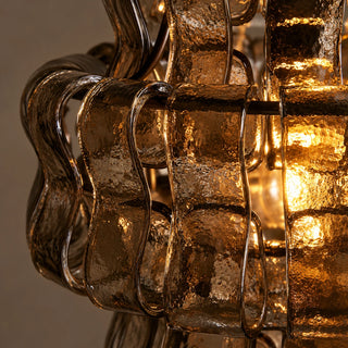 Close-up of the curved smoke gray glass panels on the Vellori pendant light