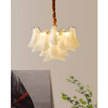 Small modern glass chandelier with layered translucent glass leaves and brass finish