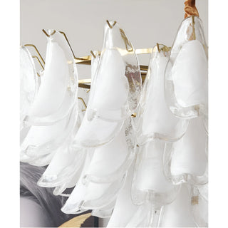 Close-up of handcrafted frosted glass elements with brass frame on Velmira chandelier