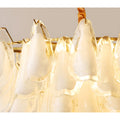 Detailed illuminated glass texture of Velmira chandelier with warm glowing light