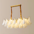 Front perspective of Velmira rectangular chandelier with cascading frosted glass shades and brushed brass frame