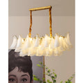 Velmira rectangular glass chandelier displayed in a modern luxury interior above decorative wall art