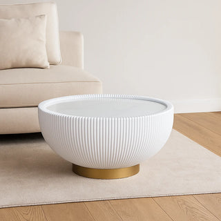 White round coffee table with gold base and marble-effect rock slab top placed in modern living room