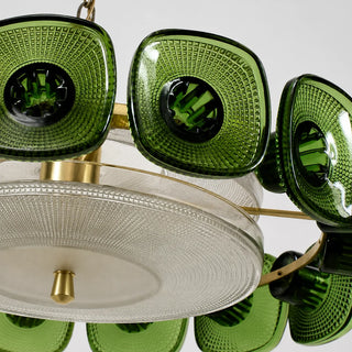 Close-up of the faceted green pressed-glass tiles and brass ring of the Vetrara chandelier