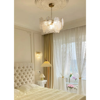 Luxury Virella glass disc chandelier illuminating elegant bedroom interior with textured Murano glass
