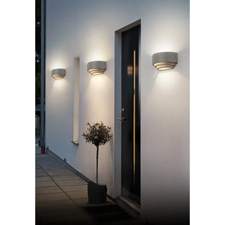 Three grey Wabi-Sabi wall sconces lining modern entry facade with symmetry
