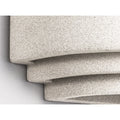 Close detail of speckled microcement texture on sculptural lighting surface