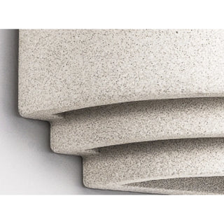 Close detail of speckled microcement texture on sculptural lighting surface