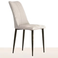 White dining chair with smooth faux leather, gently curved backrest, and matte black legs