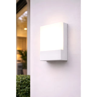 White LED wall light installed on the exterior of a modern home, illuminating the entryway