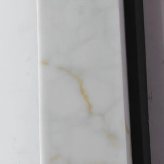 Close-up detail of faux white marble texture with subtle gold veining