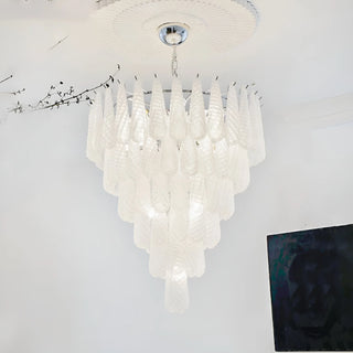 White tiered textured glass chandelier suspended in a contemporary minimalist interior