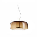 Wide coffee glass pendant light with minimalist gold base and warm LED glow