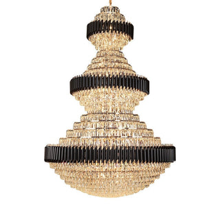Multi-tier crystal chandelier detail in a stairwell setting